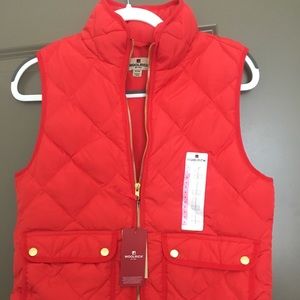 Light red down vest with front pockets and tags on